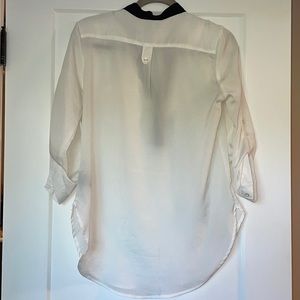 White blouse with black neckline and pocket